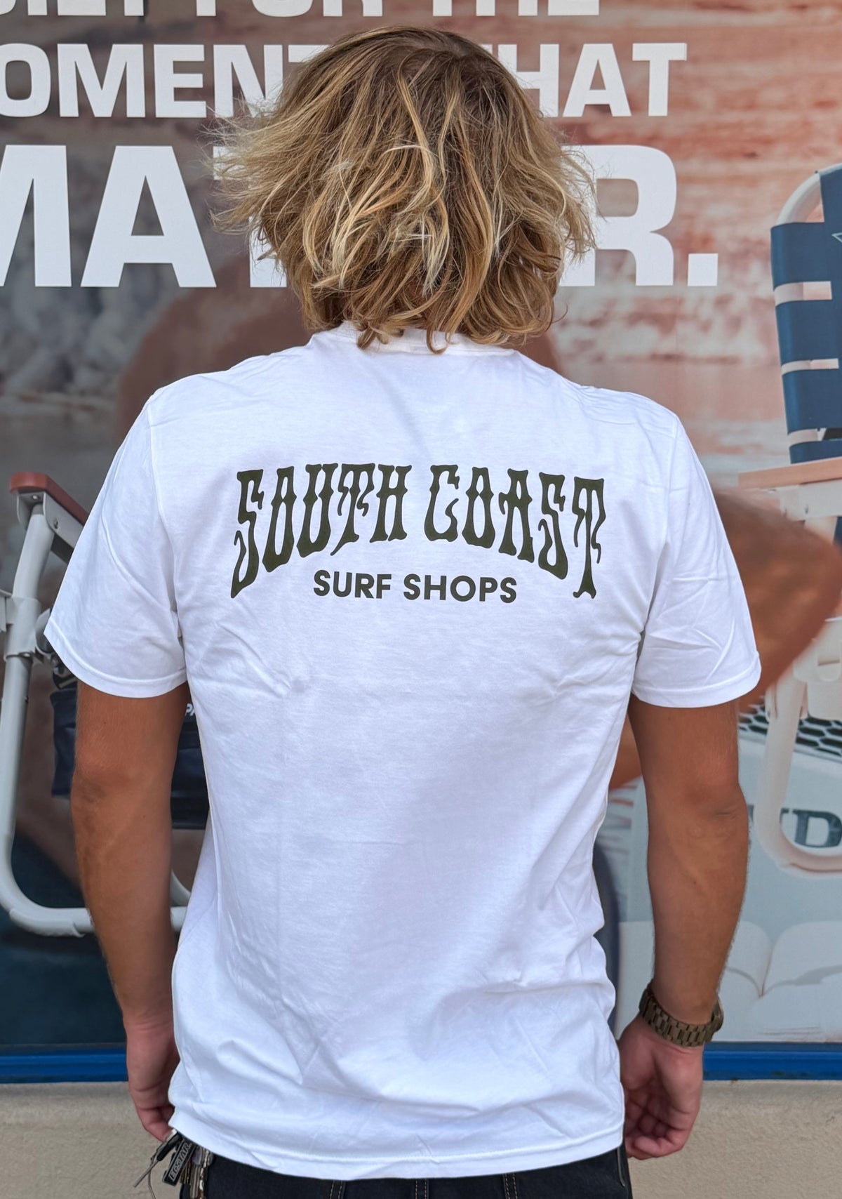 South Coast Surf Shops white graphic tee angled back view showing large black logo