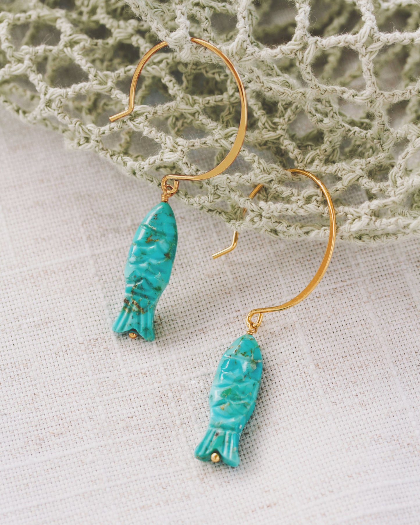 Gold fishhook hoop earrings with turquoise fish-shaped gemstone charms