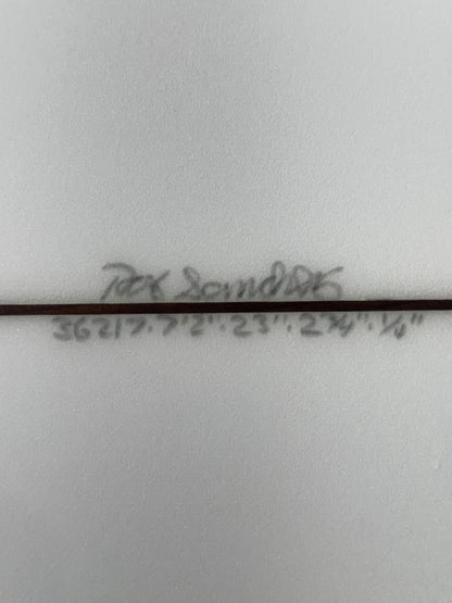 Signature and dimensions on bottom of white surfboard.   