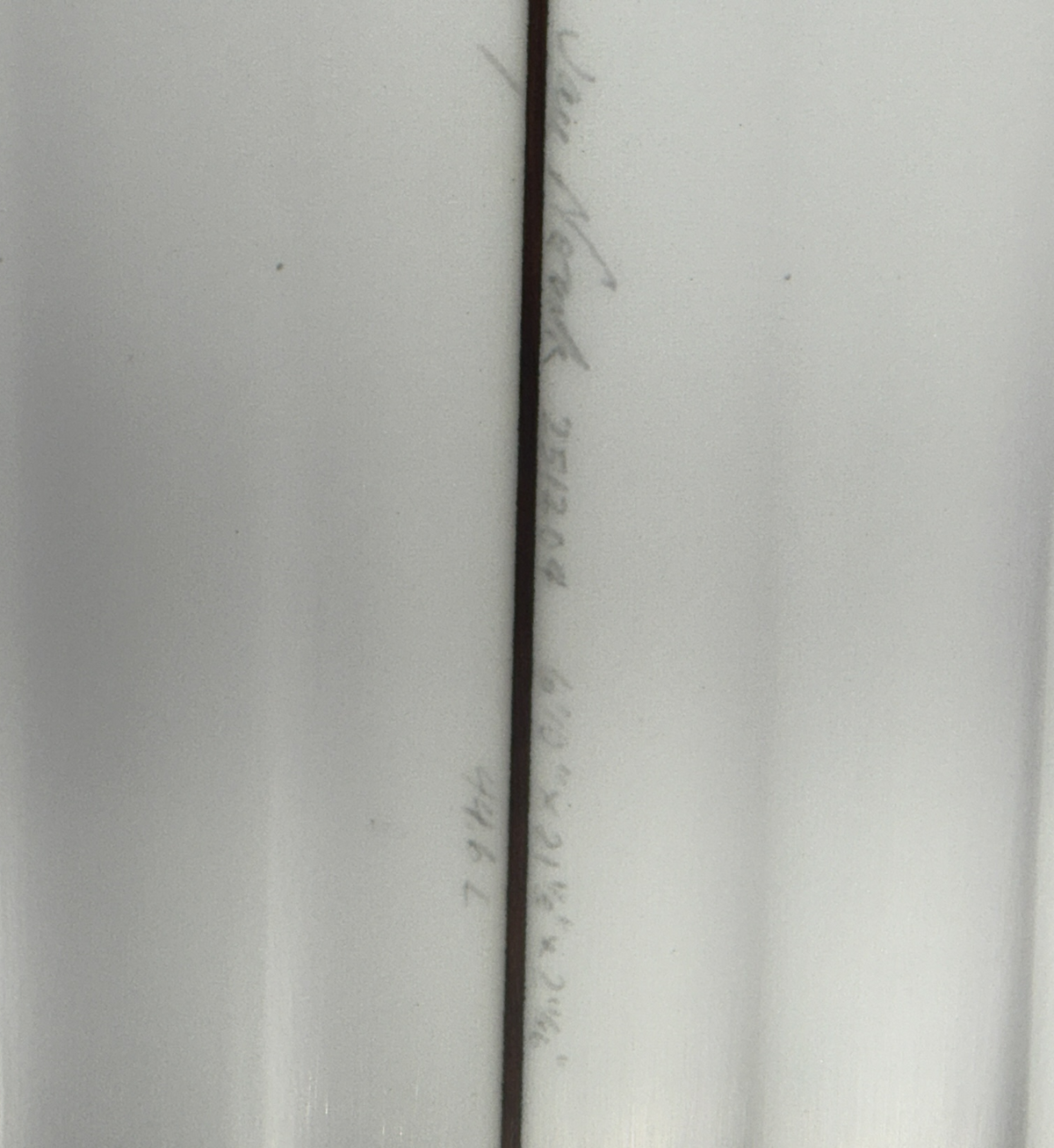 Dimensions of a AKA Twinzer on a white surfboard. 