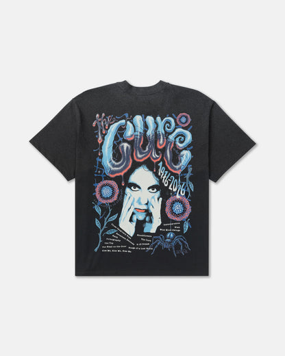 RVCA x The Cure Black Graphic Tee featuring an oversized back print with blue and red psychedelic lettering, Robert Smith artwork, flowers, and a spider.