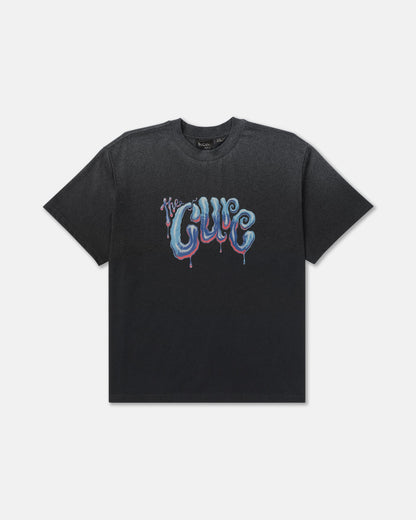RVCA x The Cure Tee in black featuring a large blue, purple, and red dripping The Cure logo across the chest with a classic crew neckline and short sleeves.