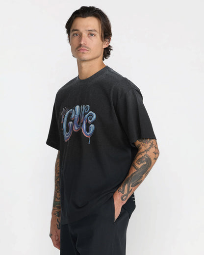 RVCA x The Cure Black Tee shown from an angled front view, highlighting the relaxed silhouette, short sleeves, and blue and purple dripping band logo.