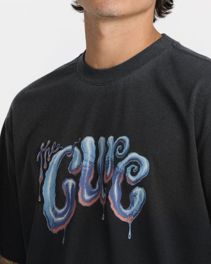Close-up of RVCA x The Cure Black T-Shirt showcasing the detailed blue, purple, and red psychedelic dripping logo printed across the chest.