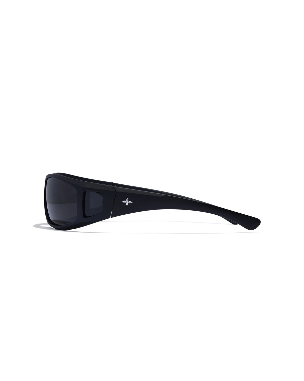 Dragster Matte Black Sunglasses with smoke lenses, a thick wraparound frame, side cutout detailing, and a white logo on the temple, shown from the side.
