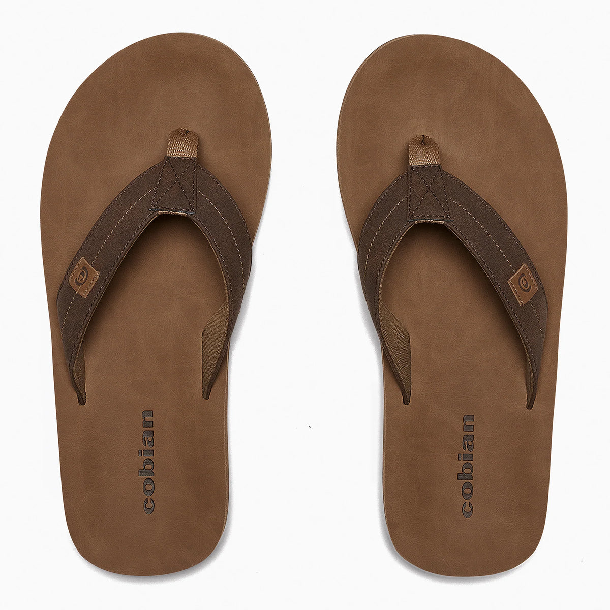Top-down view of Cobian Dunes Brown flip flops showing tan footbeds with Cobian branding, dark brown stitched straps, and woven toe posts.