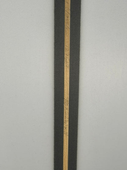 Dimensions of the surfboard with the signature of the shaper.