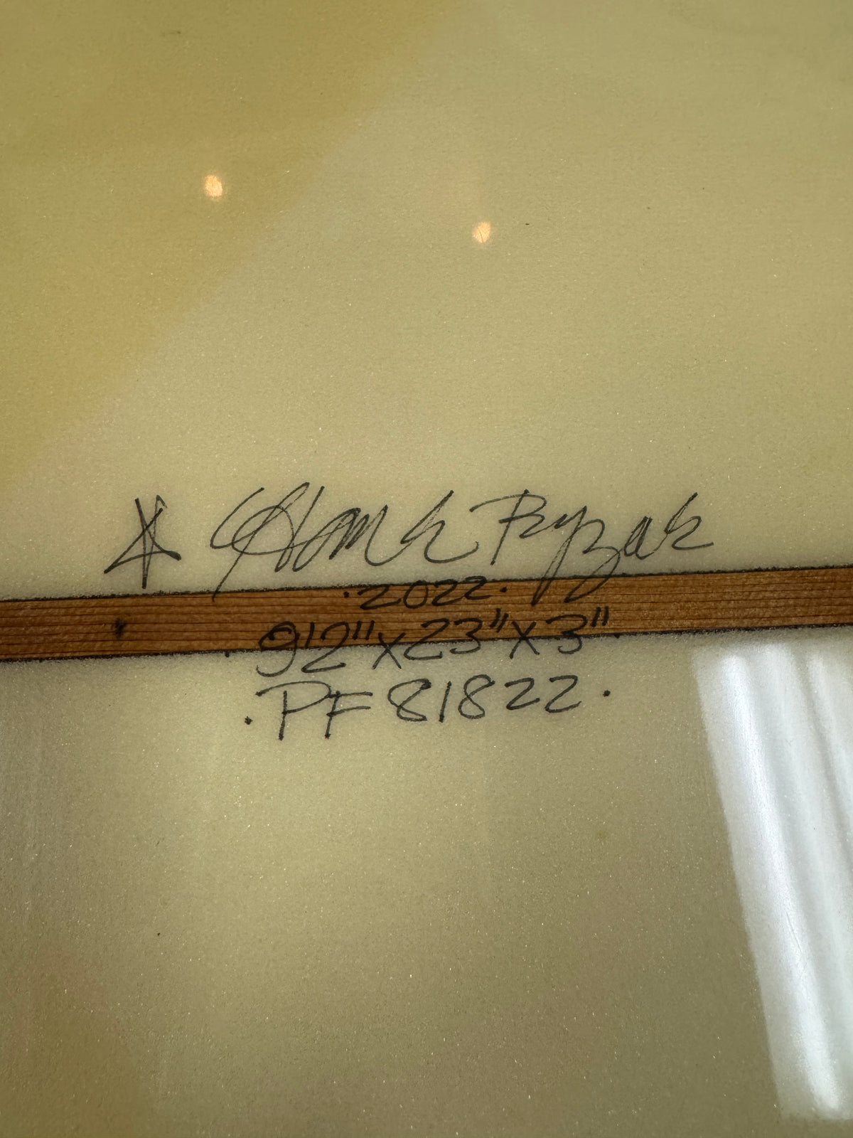 A close up shot of a Hank Byzak board with the dimensions written by hand. 