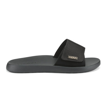 Side view of Cobian Ibiza Slide Sandal in Black showing its adjustable strap, low-profile sole, and gold Cobian branding.