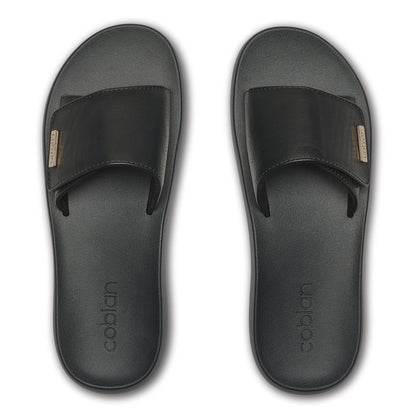 Top view of Cobian Ibiza Slide Sandals in Black highlighting the adjustable wide straps, textured footbeds, and gold logo details.