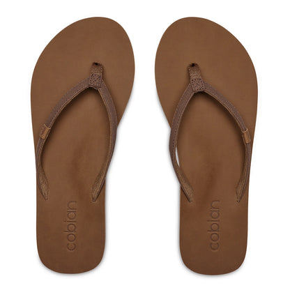 Top view of Cobian Kaia Flip Flops in Mocha showing slim V-shaped brown straps, cushioned footbeds, and embossed Cobian branding at the heels.