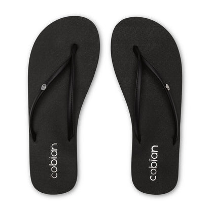 Top view of Cobian Nias Bounce 2 black flip flops featuring textured footbeds, slim black thong straps, and white Cobian heel branding.