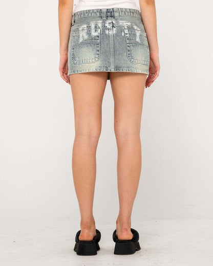 Rusty Norty Low Rise Mini Skirt in washed denim with graphic back pocket details