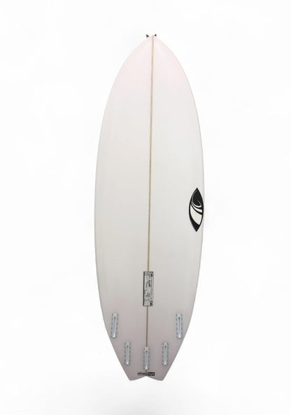A white surfboard shown from the bottom side, featuring a central stringer and a black circular logo near the tail, set against a plain white background.