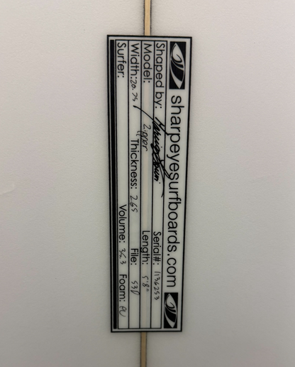 A close up of the dimensions of the a white shapeye surfboard. 