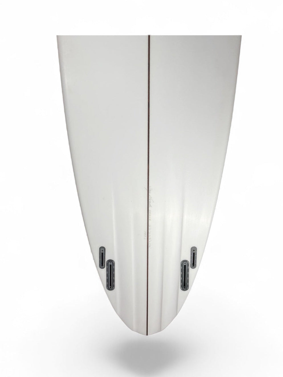 Tail of a white surfboard with 4 black fin boxes and channels. 