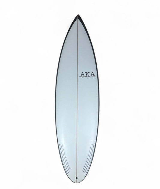 White surfboard with black rails on a white background. 