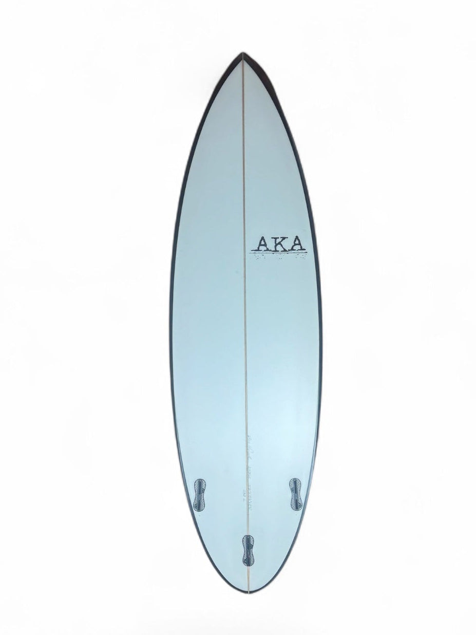 Bottom of a white surfboard with black rails on a white background. 