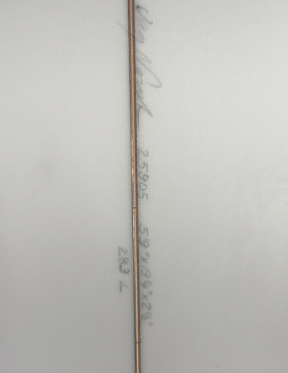 The underside of a white surfboard that includes writing of the boards dimensions. 