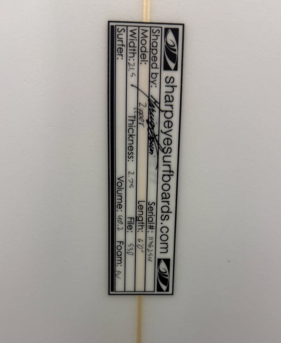 A close up of the dimensions of a white sharpeye surfboard. 