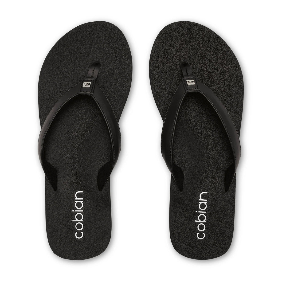 Top view of Cobian Skinny Bounce black flip flops featuring textured footbeds, wide black thong straps, and white Cobian heel branding.