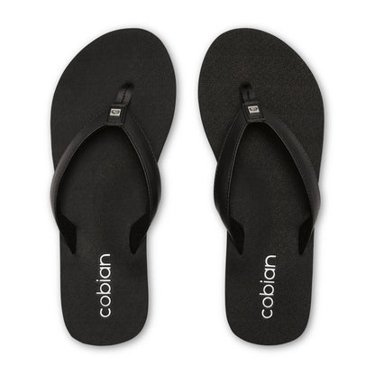 Top view of Cobian Skinny Bounce black flip flops featuring textured footbeds, wide black thong straps, and white Cobian heel branding.