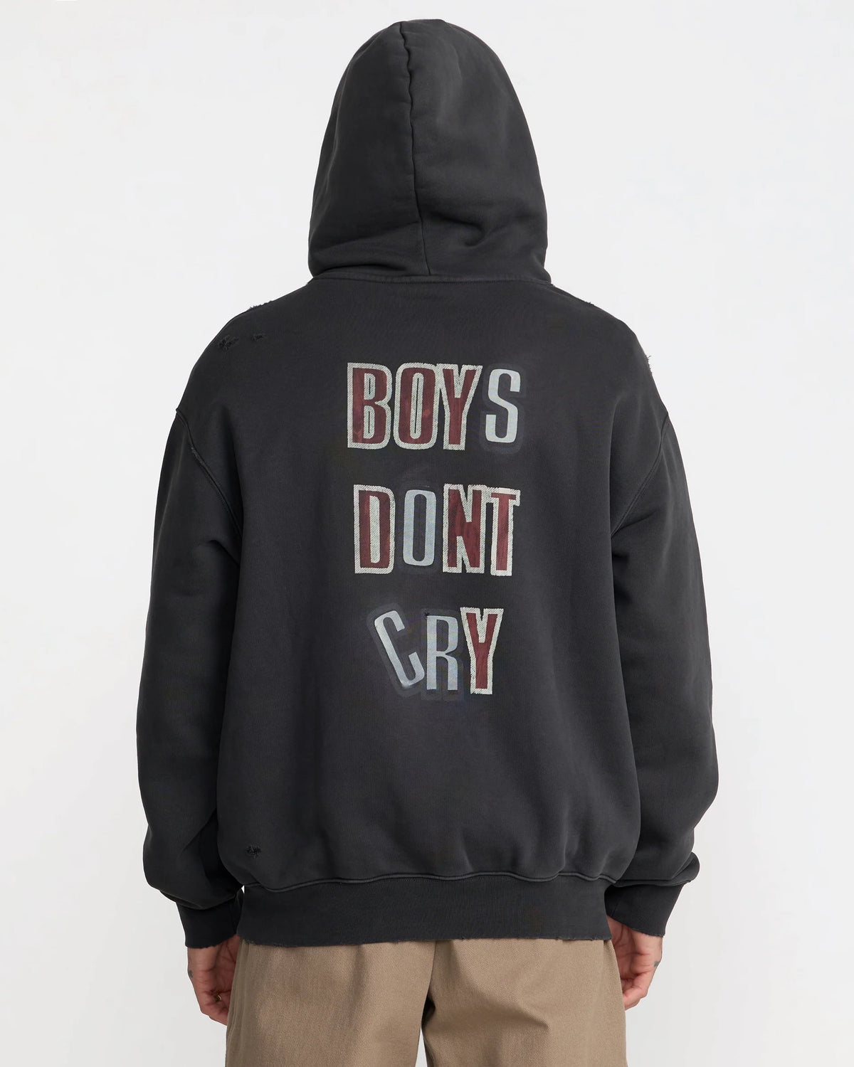 The Cure Boys Don't Cry Hoodie in washed black modeled from behind, showcasing the oversized fit, ribbed hem, and vintage-style back graphic.