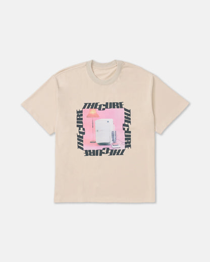 RVCA x The Cure Tee in cream featuring a pink vintage-inspired refrigerator and lamp graphic surrounded by bold black The Cure lettering.