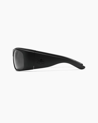 Transmitter by NOA Matte Black Sunglasses with smoke lenses, wide tapered temples, embossed logo detailing, and curved arms, shown from the side.