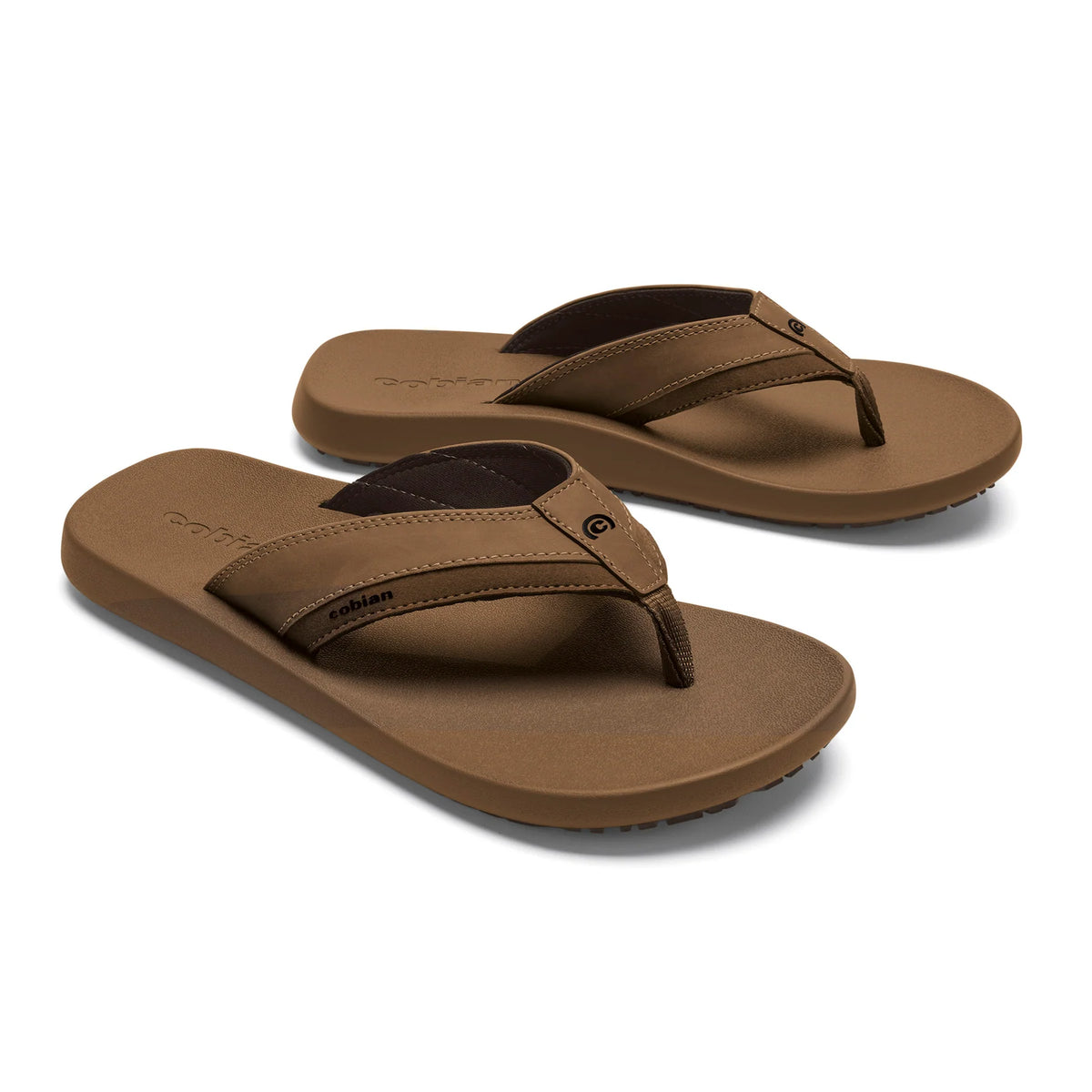 Pair of Cobian Venture Men's Flip Flops in Tan showing textured footbeds, wide stitched straps, dark brown lining, and Cobian branding.
