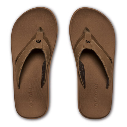 Top view of Cobian Venture Men's Flip Flops in Tan featuring textured brown footbeds, tan stitched thong straps, dark brown lining, and embossed Cobian logos.